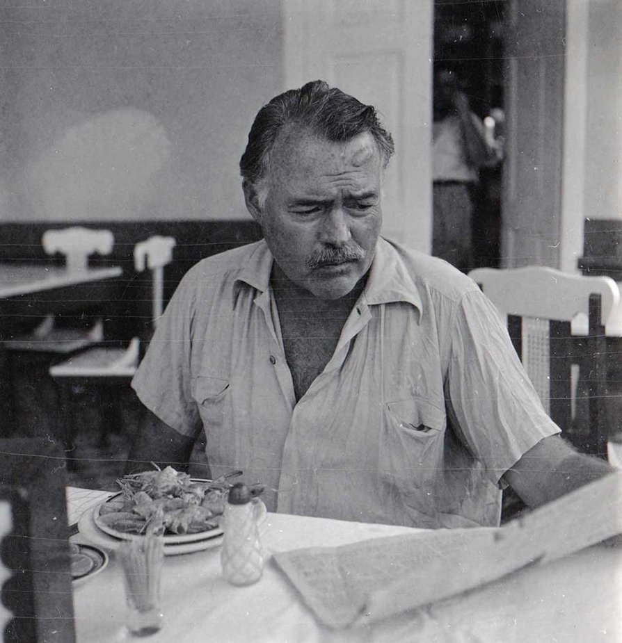 Ernest Hemingway reading a newspaper, Cuba, 1947-1948. Cr: Ernest Hemingway Collection. John F. Kennedy Presidential Library and Museum, Boston