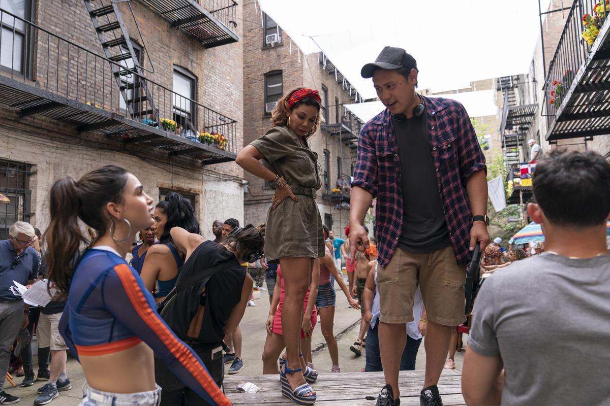 Melissa Barrera, Daphne Rubin-Vega and director Jon M. Chu on the set of the screen adaptation of “In The Heights.” Cr: Macall Polay/Warner Bros.