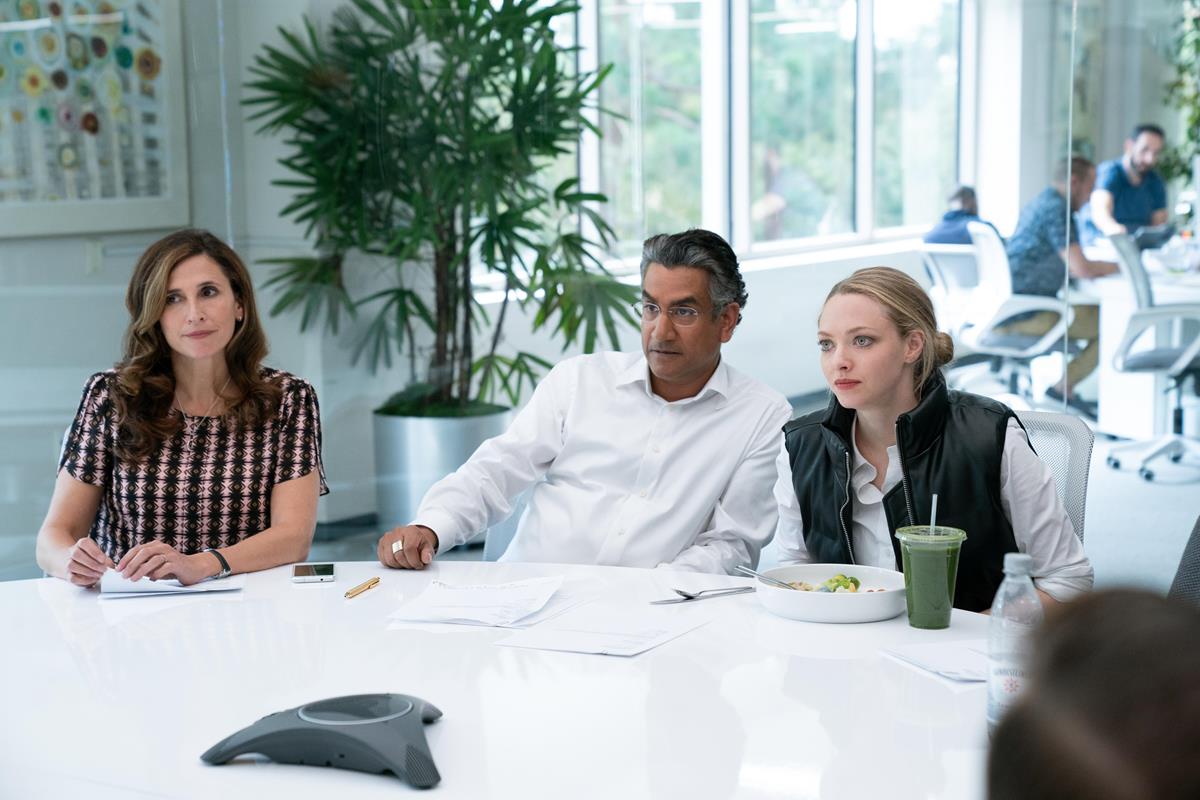 Michaela Watkins as Linda Tanner, Naveen Andrews as Sunny Balwani, and Amanda Seyfried as Elizabeth Holmes in episode 7 of “The Dropout.” Cr: Beth Dubber/Hulu